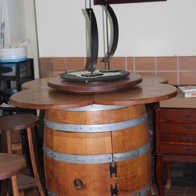 Repurposed wine barrel pub table featuring a cloverleaf-shaped wooden top, built-in storage cabinet, and lazy Susan turntable.