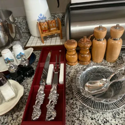 Assortment of vintage kitchenware, including a boxed carving set with ornate silver-tone handles, various wooden and ceramic salt and...