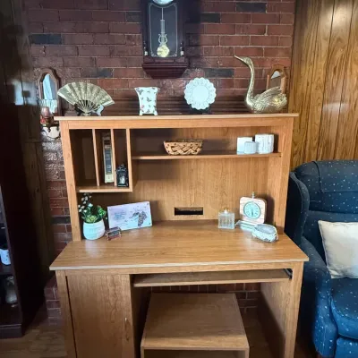 Light oak finish computer desk with a matching hutch and a rolling printer cart, shown decorated with various home decor items.