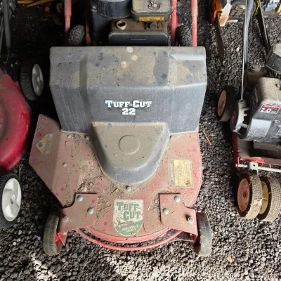 Sale Photo Thumbnail #55: Vintage Tuff-Cut 22 high-wheel walk-behind lawn mower, showing significant dirt and wear from use.