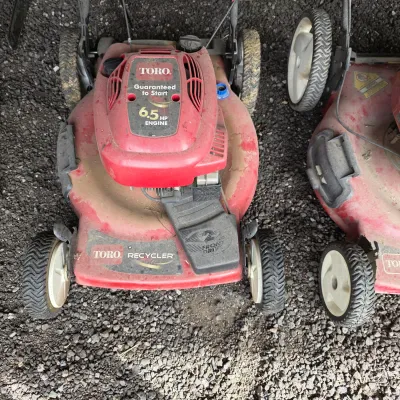 Sale Photo Thumbnail #53: Toro Recycler walk-behind lawn mower featuring a 6.5 HP engine and front-wheel drive, showing moderate wear and dirt from use.