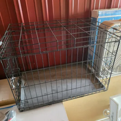 Sale Photo Thumbnail #101: Black wire dog crate with a removable plastic bottom tray, showing some light wear from use.