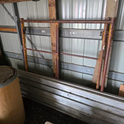 Sale Photo Thumbnail #36: Vintage metal scaffolding frames with weathered yellow and red paint, showing signs of rust and wear from use.