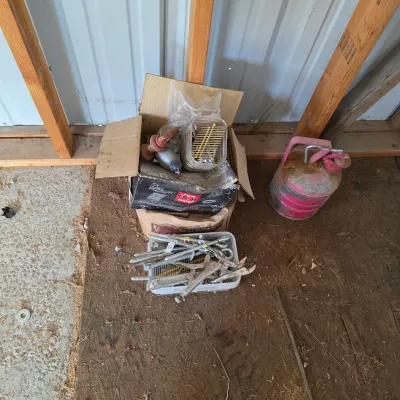Sale Photo Thumbnail #88: Assorted hardware and tools, including a box of nails, a plastic bin with bolts and locking pliers, and a weathered pink metal gas can.
