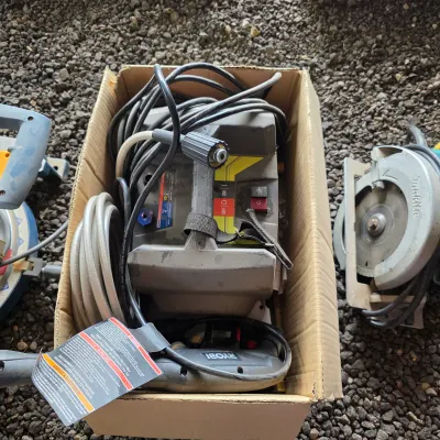 Sale Photo Thumbnail #43: Ryobi electric pressure washer with hoses and power cord, stored inside a cardboard box alongside other power tools.