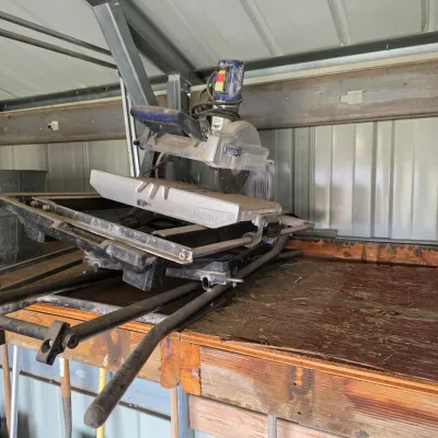 Sale Photo Thumbnail #27: Kobalt wet tile saw with stand, showing signs of moderate use and storage wear.