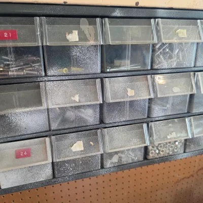 Sale Photo Thumbnail #68: Vintage multi-drawer plastic organizer filled with various hardware, including screws, rivets, and nuts.