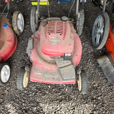 Sale Photo Thumbnail #52: Toro Recycler 22-inch front-wheel drive walk-behind lawn mower, showing some dust and wear from use.