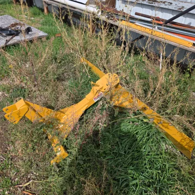 Sale Photo Thumbnail #78: Yellow Befco 3-point hitch rear grader blade, showing some wear and partially obscured by weeds.