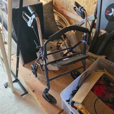 Sale Photo Thumbnail #99: Drive Medical blue four-wheel rollator walker with a padded seat and hand brakes, shown in used condition.