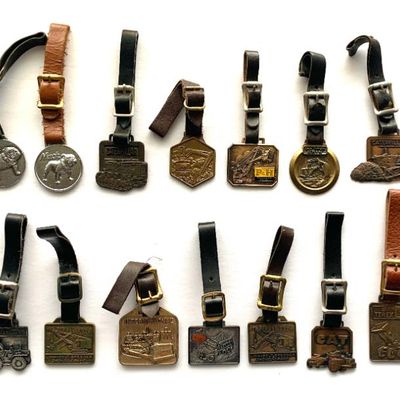 Collection of vtg. truck and equipment related watch fobs.