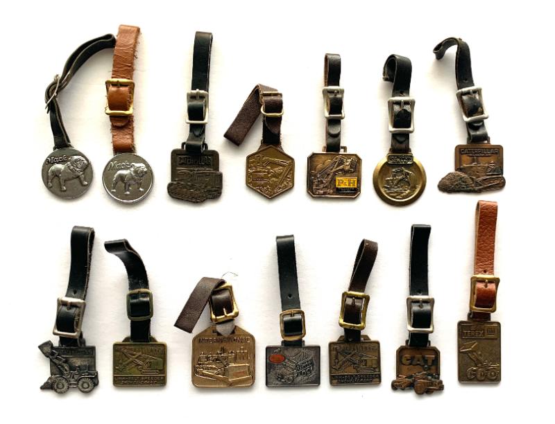 Collection of vtg. truck and equipment related watch fobs.