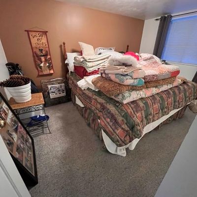 Bed, quilts, blankets, and pillows, small side tables