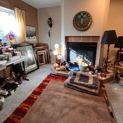 artwork, table lamps, decorative rugs, and various home decor pieces 