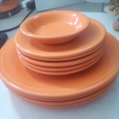 A Set of Tangerine Fiestaware Glazed Ceramic Tableware