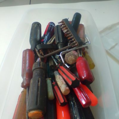 An Assortment of Multi-Brand Hand Tools and Driver Bits in Storage Bin