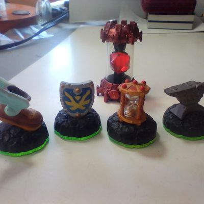 A Collection of Skylanders Interactive Game Pieces and Fire Creation Crystal