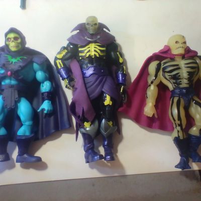 An Assortment of Masters of the Universe Action Figures and Accessories Featuring Skeletor and Scare Glow