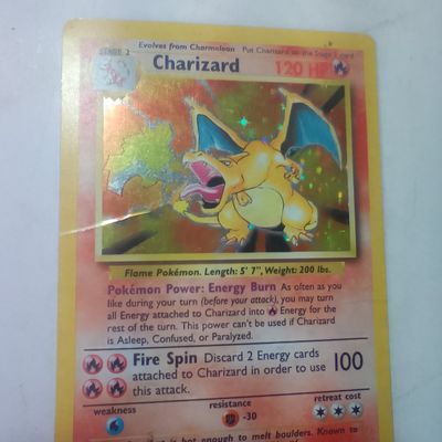 1999 Pokémon TCG Base Set Charizard Holographic Card 4/102 see picture for details it has a wrinkle line we show