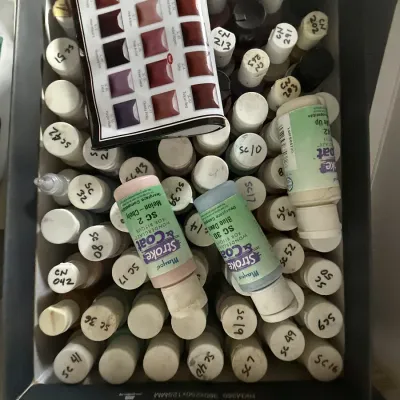 Mayco Stroke & Coat glaze bottles and a color chart for ceramic painting.