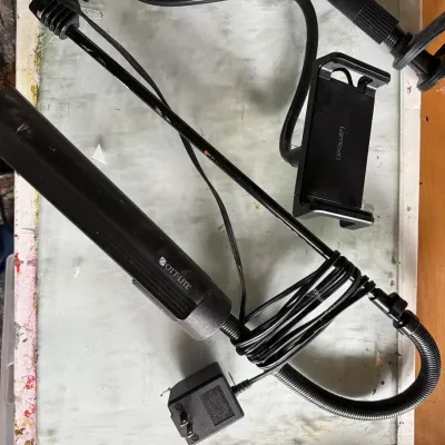 Black Ott-Lite flexible task light alongside a Lamicall gooseneck smartphone holder mount