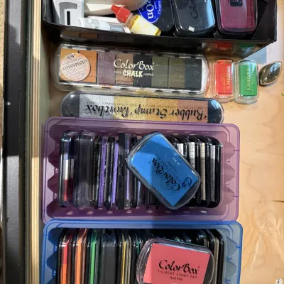 Large assortment of crafting stamp ink pads and chalk palettes, featuring brands like ColorBox and Kaleidacolor, organized in plastic...