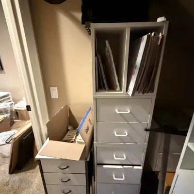 Tall white modular craft storage unit with six drawers and top shelving sections