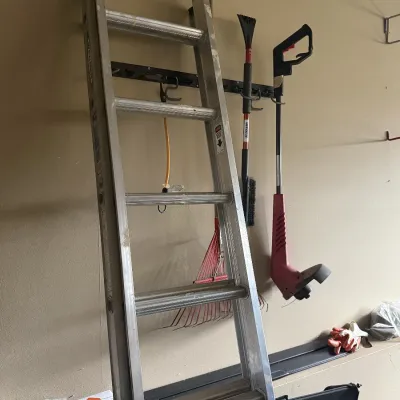 Aluminum extension ladder, electric weed trimmer & rake.