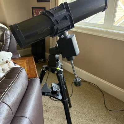 Galileo reflector telescope mounted on an adjustable tripod with counterweight assembly.