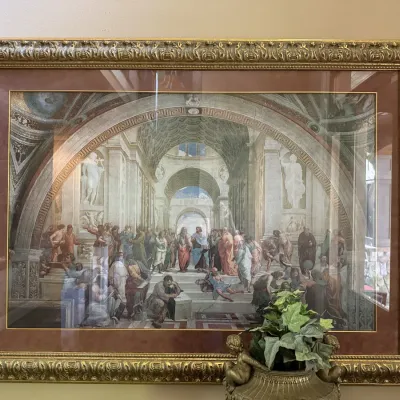 Framed print depicting Raphael's The School of Athens, set in a heavily ornate gold composition frame with a double mat.