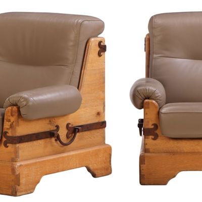 LARGE SCALE PAIR OF FRENCH BRUTALIST STYLE GOUGE CARVED OAK LOUNGE CHAIRS WITH IRON DECORATION AND