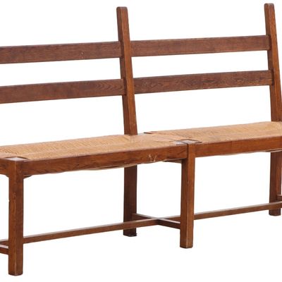 FRENCH BRUTALIST OAK AND RUSH BENCH HAVING ELONGATED UPRIGHTS C 1950. PART OF A FOUR PIECE