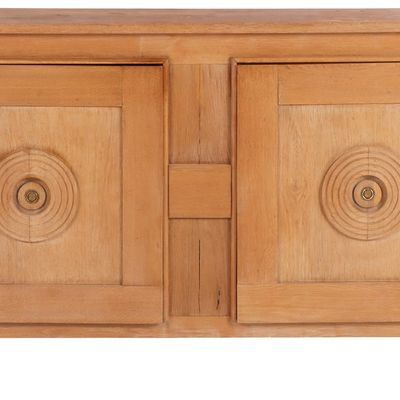 FRENCH OAK SERVER HAVING TWO DOORS AND CIRCULAR DESIGN IN THE MANNER OF CHARLES DUDOUYT C 1940.