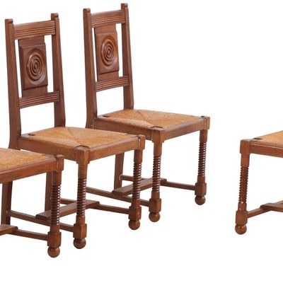 FOUR FRENCH OAK SIDE CHAIRS C 1940 HAVING CIRCULAR MOTIFS,  TURNED LEGS AND BALL FEET IN THE MANNER