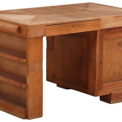 A FRENCH OAK DESK ATTRIBUTED TO CHARLES DUDOUYT C 1940 HAVING OPEN BOOKCASE END AND DOORS ON BOTH