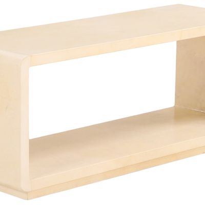PARCHMENT COVERED COFFEE TABLE OR BENCH WITH WATERFALL EDGE FLOATING ON A RECESSED BASE.