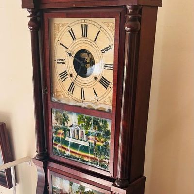 Sale Photo Thumbnail #11: Antique mahogany triple-decker shelf clock featuring a painted dial, Roman numerals, and reverse-painted glass landscape panels.