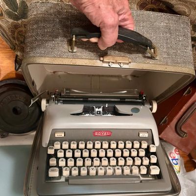 Sale Photo Thumbnail #74: Vintage Royal portable typewriter with its original tweed-patterned carrying case.
