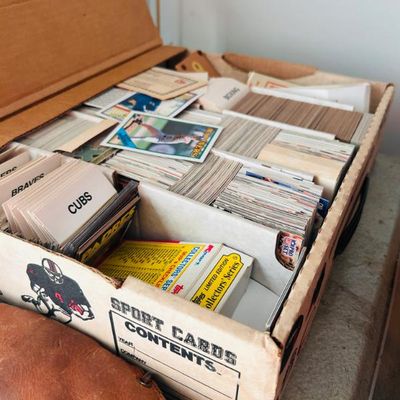 Sale Photo Thumbnail #12: Vintage sports card collection organized in a cardboard storage box, featuring various baseball cards with team dividers and a Topps Collectors' Series box.