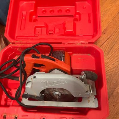 Sale Photo Thumbnail #4: Milwaukee corded circular saw inside its original red hard-shell carrying case.