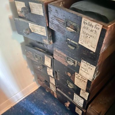 Sale Photo Thumbnail #93: Vintage wooden multi-drawer parts cabinet featuring handwritten labels for clock components like "Big Ben Wheels" and "New Baby Ben Glasses."