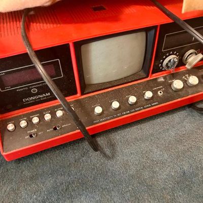 Sale Photo Thumbnail #5: Vintage Dongnam model DV-535CR red portable television with built-in AM/FM radio and digital clock.