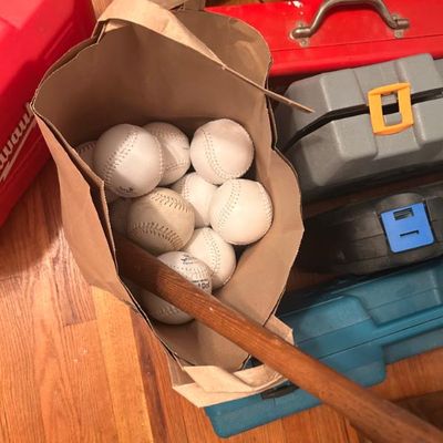 Sale Photo Thumbnail #83: Collection of white baseballs in a brown paper bag, wooden bat handle and various toolboxes.