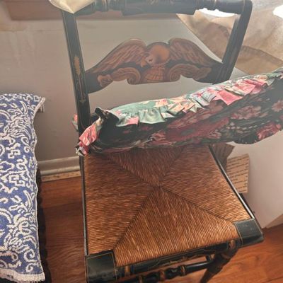 Sale Photo Thumbnail #65: Hitchcock-style black painted side chair featuring a woven rush seat, gold stenciled details, and an eagle motif on the backrest.