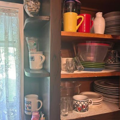 Sale Photo Thumbnail #44: Assorted kitchenware including ceramic mugs, plates, bowls, and glassware.