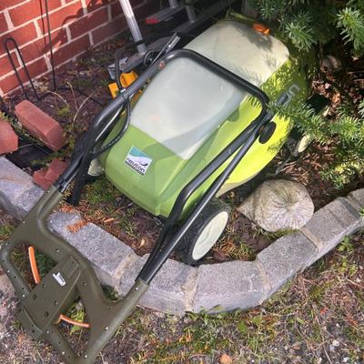 Sale Photo Thumbnail #104: Neuton battery-powered electric lawn mower with a lime green and grey body.