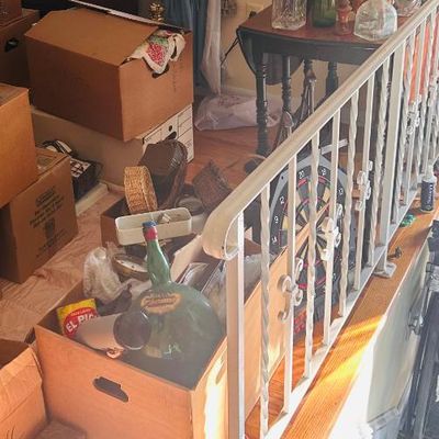 Sale Photo Thumbnail #55: vintage glassware, decorative bottles, a dartboard, and various packed boxes.