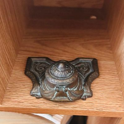 Sale Photo Thumbnail #57: Antique cast metal inkwell featuring ornate scrollwork and a hinged lid.