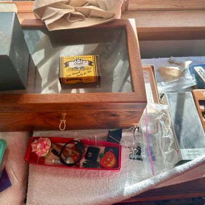 Sale Photo Thumbnail #62: Wooden display case with a glass lid, shown alongside various small vintage collectibles and office supplies.