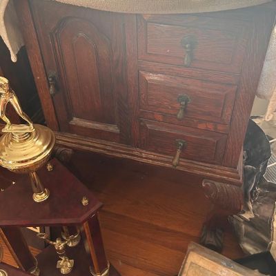Sale Photo Thumbnail #63: Vintage dark oak nightstand or side table featuring a single cabinet door, three drawers with ornate drop pulls, and carved cabriole legs.